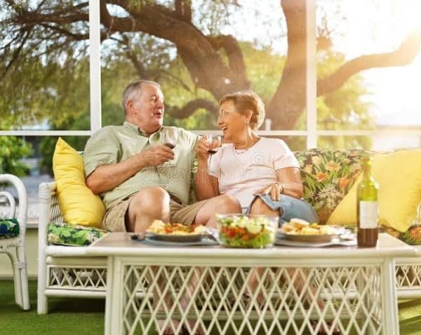 Couple relaxing on a sunny patio with drinks